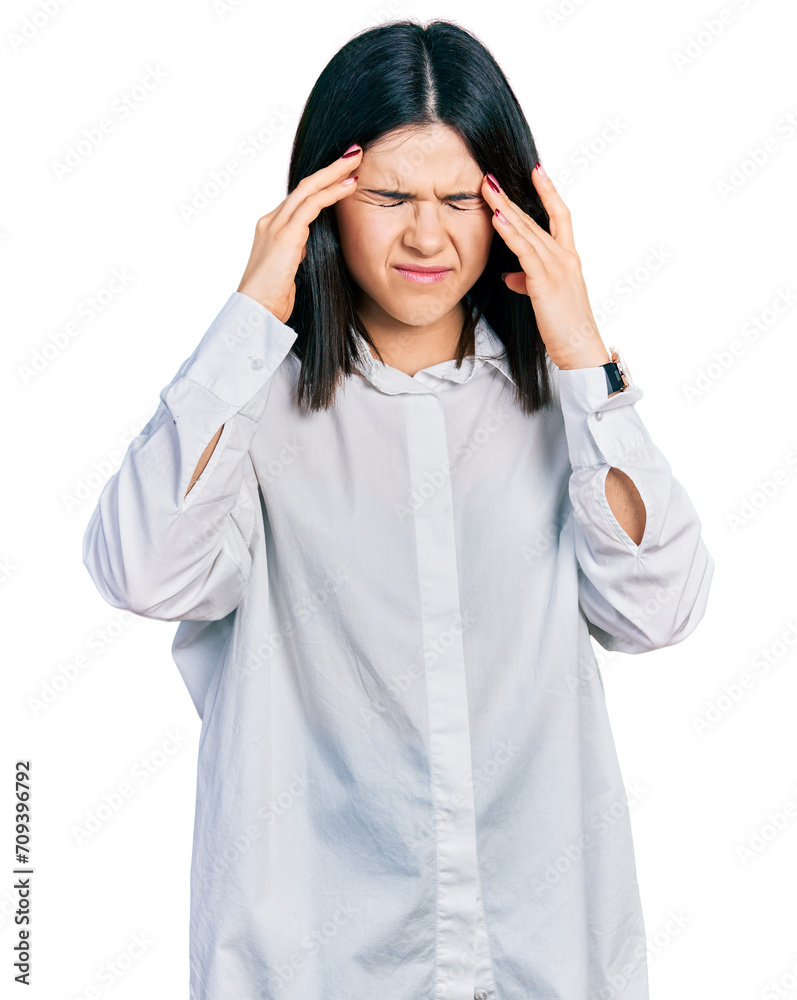 Young brunette woman with blue eyes wearing oversize white shirt with hand on head, headache because stress. suffering migraine. Young brunette woman with blue eyes wearing oversize white shirt with hand on head, headache because stress. suffering migraine.