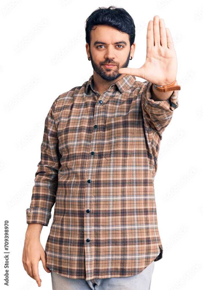 Young hispanic man wearing casual clothes doing stop sing with palm of the hand. warning expression with negative and serious gesture on the face. Young hispanic man wearing casual clothes doing stop sing with palm of the hand. warning expression with negative and serious gesture on the face.