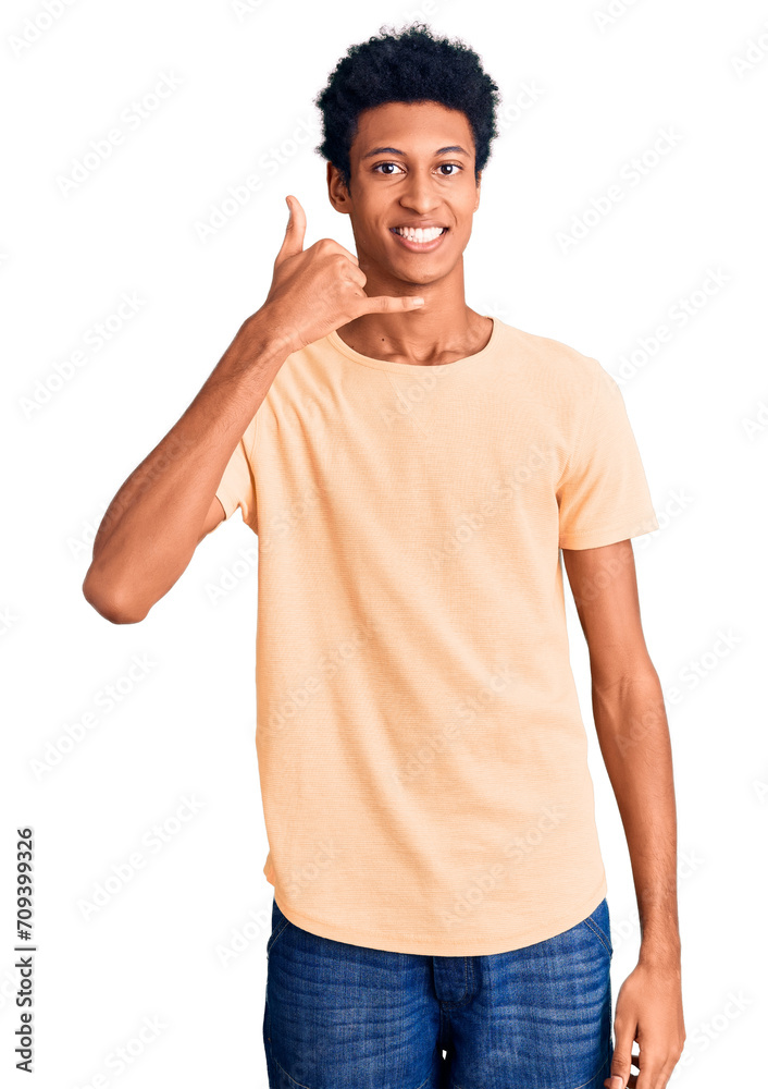 Young african american man wearing casual clothes smiling doing phone gesture with hand and fingers like talking on the telephone. communicating concepts. Young african american man wearing casual clothes smiling doing phone gesture with hand and fingers like talking on the telephone. communicating concepts.
