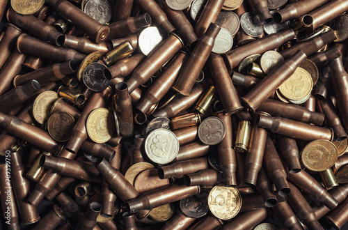 Photo of Russian coins laying on empty AK rifle bullet shells.