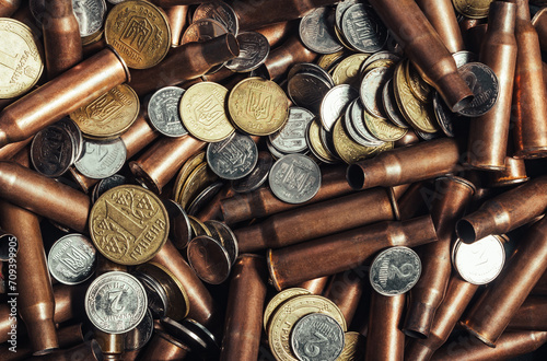 Photo o Ukrainian coins laying on empty copper bullet shells.