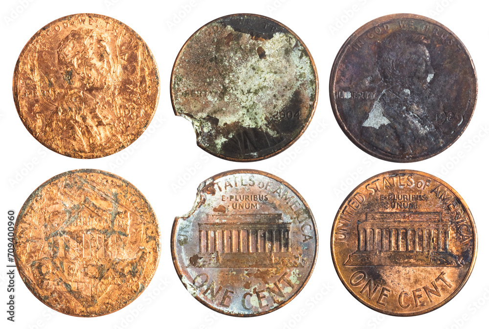Isolated photo of old rusty and damaged american 1 cent coins on white background. Isolated photo of old rusty and damaged american 1 cent coins on white background.