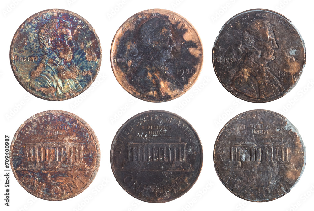 Isolated photo of old rusty and burned american 1 cent coins on white background.