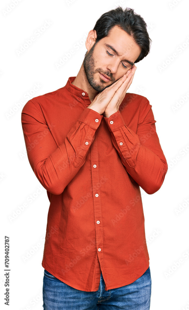 Young hispanic man wearing casual clothes sleeping tired dreaming and posing with hands together while smiling with closed eyes. Young hispanic man wearing casual clothes sleeping tired dreaming and posing with hands together while smiling with closed eyes.