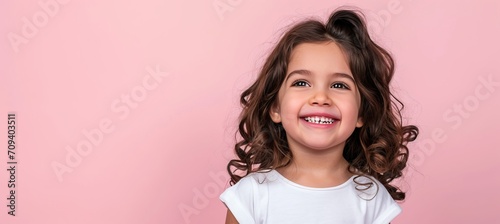 Smiling american girl child model with clean teeth, pink background   perfect for ads and web design
