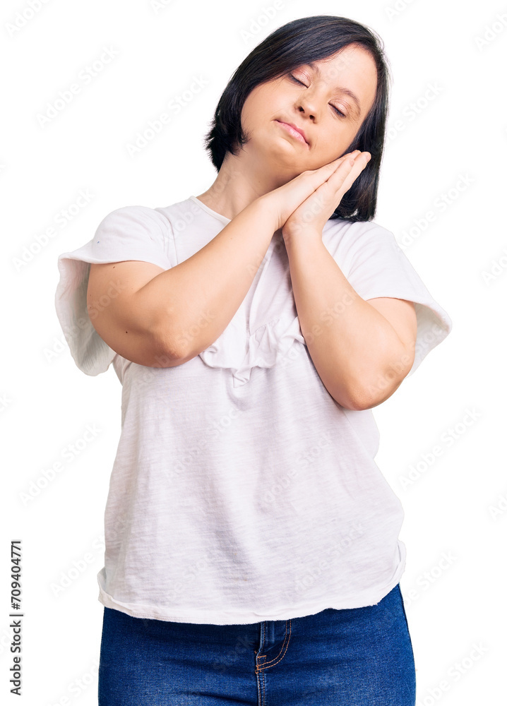 Brunette woman with down syndrome wearing casual white tshirt sleeping tired dreaming and posing with hands together while smiling with closed eyes. Brunette woman with down syndrome wearing casual white tshirt sleeping tired dreaming and posing with hands together while smiling with closed eyes.