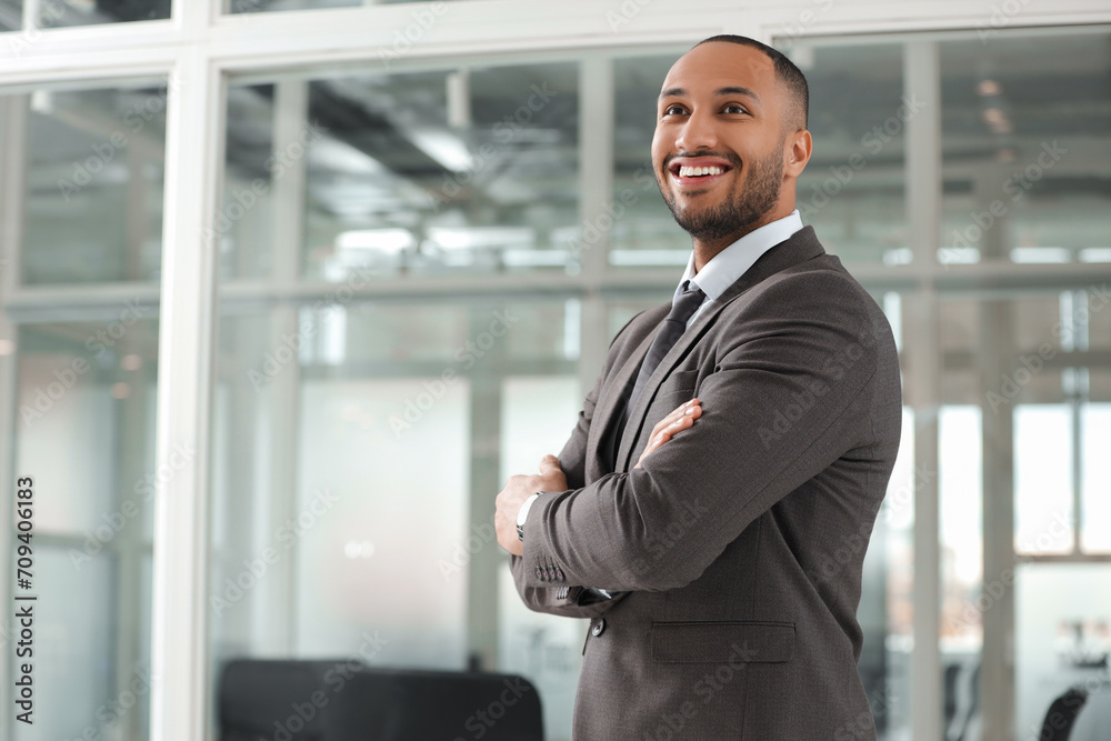 Happy man with crossed arms in office, space for text. Lawyer, businessman, accountant or manager Happy man with crossed arms in office, space for text. Lawyer, businessman, accountant or manager