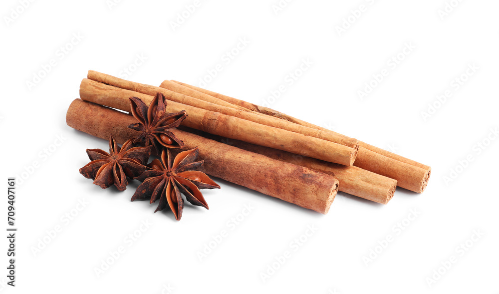 Aromatic cinnamon sticks and anise stars isolated on white Aromatic cinnamon sticks and anise stars isolated on white