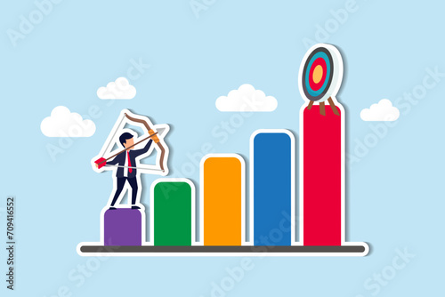 Business challenge to achieve higher target, ambition and aspiration to improve or aiming for success goal concept, confidence businessman aiming his bow arrow to top of high performance target.