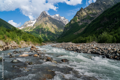 View of the Dombay-Ulgen gorge in the mountains of the North Caucasus near the village of Dombay on a sunny summer day, Karachay-Cherkessia, Russia