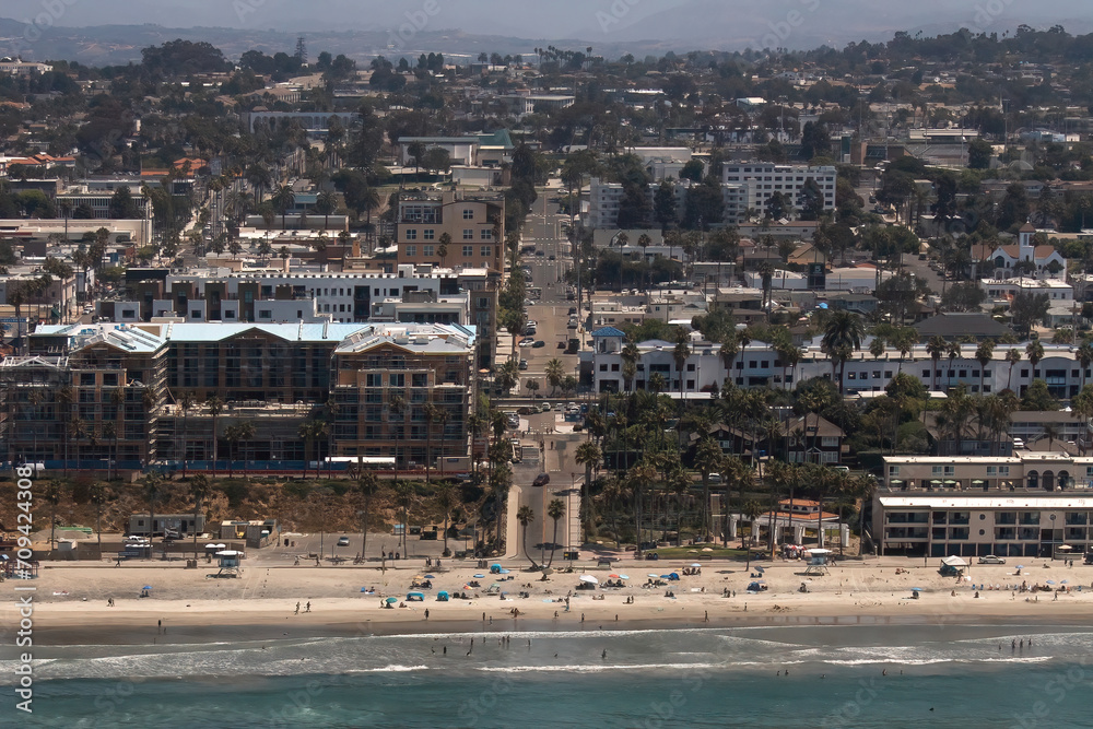 Oceanside community on a beach in California. Bustling and thriving tourist destination where you can shop, eat, and entertain. Sand and palm trees guide the way into the lax life of the west coast