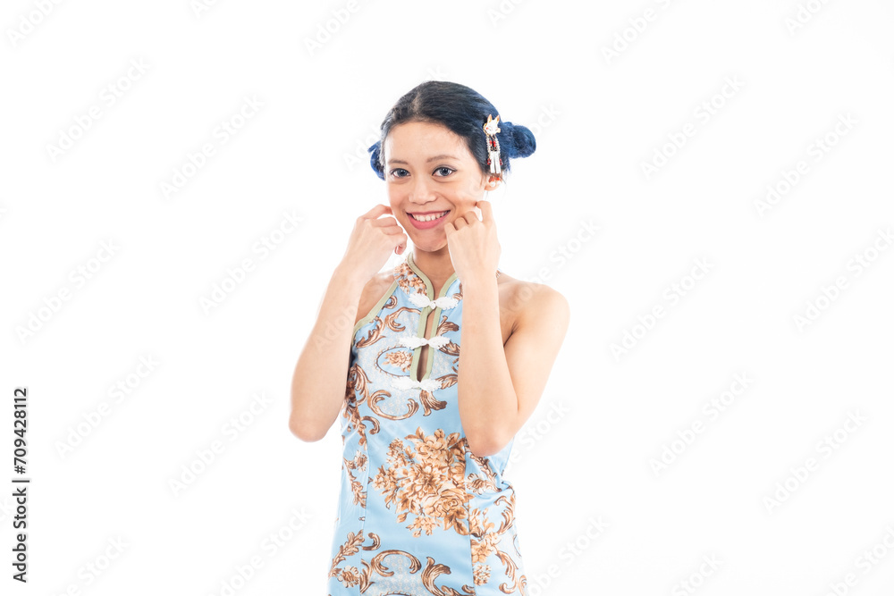 Portrait of an attractive Asian Chinese female wearing cheongsam or qipao isolated on white background for Chinese New Year concept Portrait of an attractive Asian Chinese female wearing cheongsam or qipao isolated on white background for Chinese New Year concept