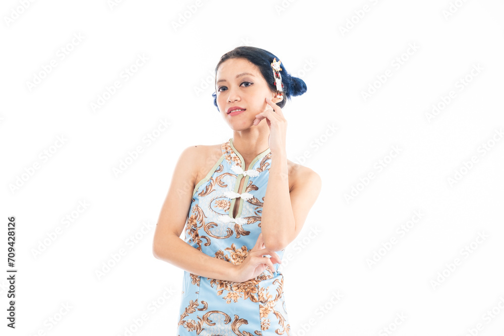 Portrait of an attractive Asian Chinese female wearing cheongsam or qipao isolated on white background for Chinese New Year concept
