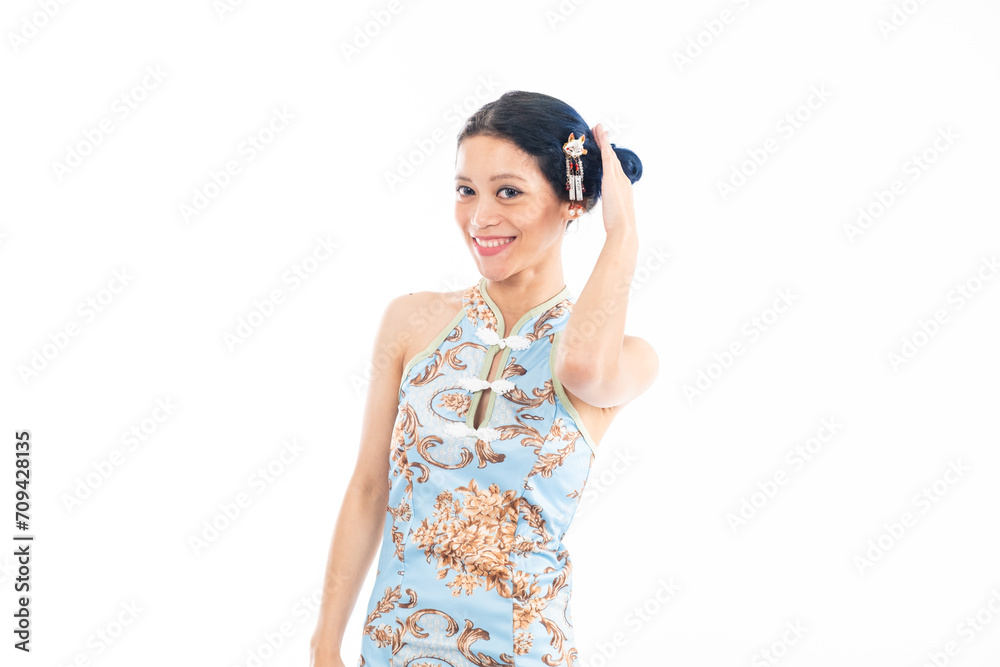 Portrait of an attractive Asian Chinese female wearing cheongsam or qipao isolated on white background for Chinese New Year concept Portrait of an attractive Asian Chinese female wearing cheongsam or qipao isolated on white background for Chinese New Year concept