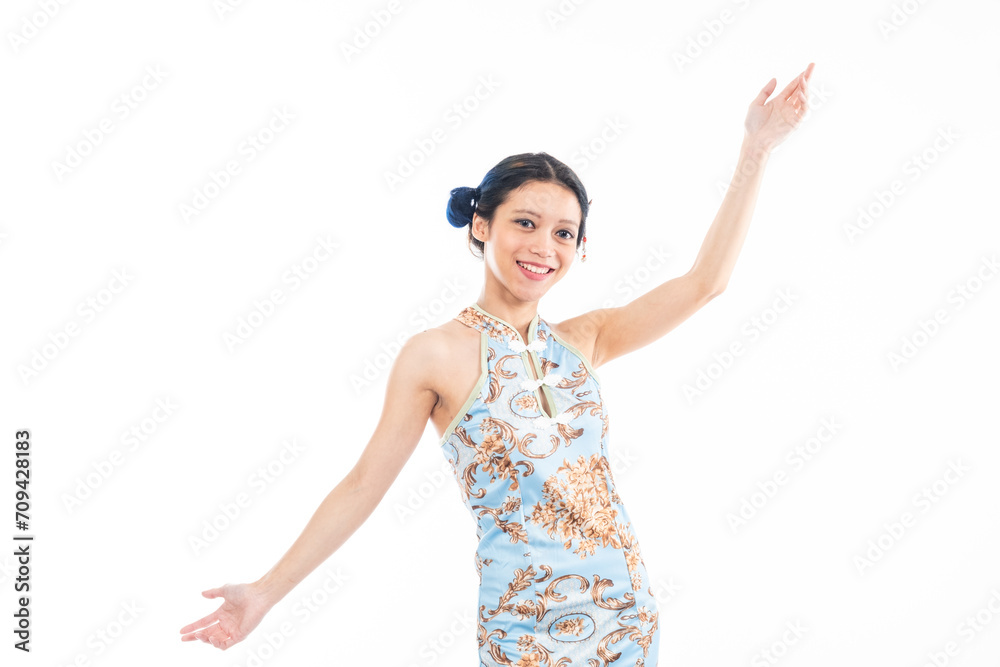 Portrait of an attractive Asian Chinese female wearing cheongsam or qipao isolated on white background for Chinese New Year concept Portrait of an attractive Asian Chinese female wearing cheongsam or qipao isolated on white background for Chinese New Year concept