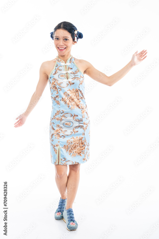 Portrait of an attractive Asian Chinese female wearing cheongsam or qipao isolated on white background for Chinese New Year concept Portrait of an attractive Asian Chinese female wearing cheongsam or qipao isolated on white background for Chinese New Year concept