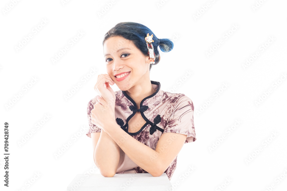 Portrait of an attractive Asian Chinese female wearing cheongsam or qipao isolated on white background for Chinese New Year concept Portrait of an attractive Asian Chinese female wearing cheongsam or qipao isolated on white background for Chinese New Year concept
