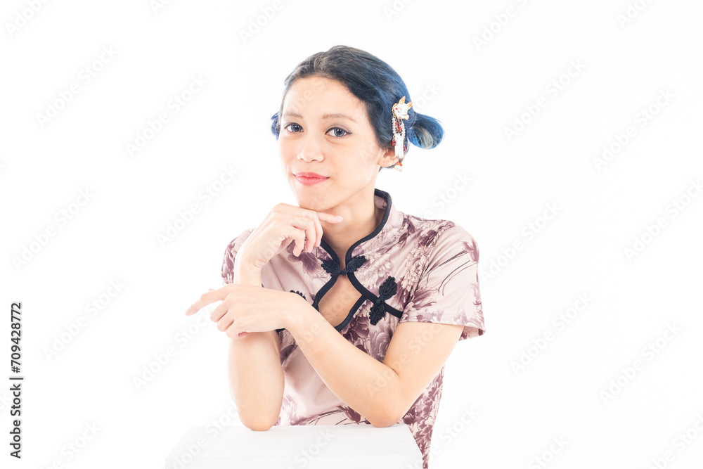 Portrait of an attractive Asian Chinese female wearing cheongsam or qipao isolated on white background for Chinese New Year concept Portrait of an attractive Asian Chinese female wearing cheongsam or qipao isolated on white background for Chinese New Year concept