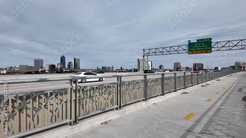 Traffic passing by on the Fuller Warren Bridge with downtown Jacksonville in the background. photo