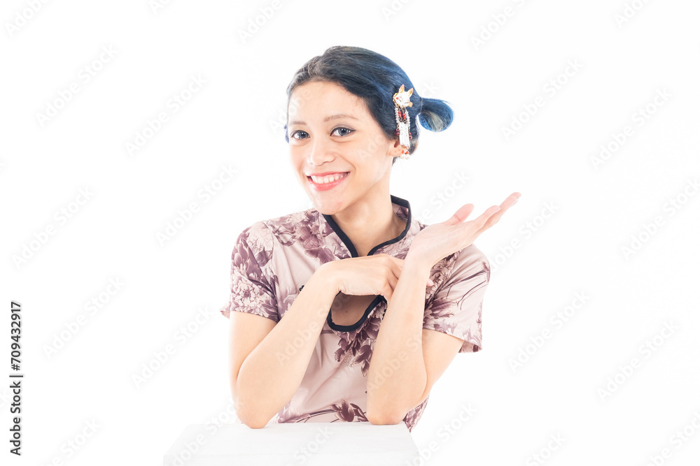 Closeup portrait of an attractive Asian Chinese female wearing cheongsam or qipao isolated on white background for Chinese New Year concept Closeup portrait of an attractive Asian Chinese female wearing cheongsam or qipao isolated on white background for Chinese New Year concept