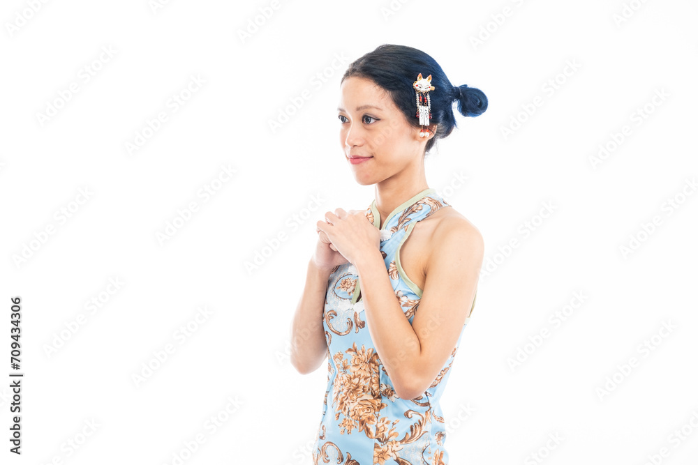 Portrait of an attractive Asian Chinese female wearing cheongsam or qipao isolated on white background for Chinese New Year concept Portrait of an attractive Asian Chinese female wearing cheongsam or qipao isolated on white background for Chinese New Year concept