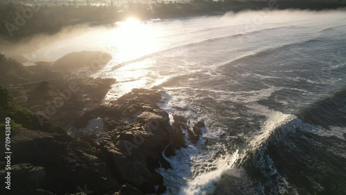 Drone over coastal point with waves photo