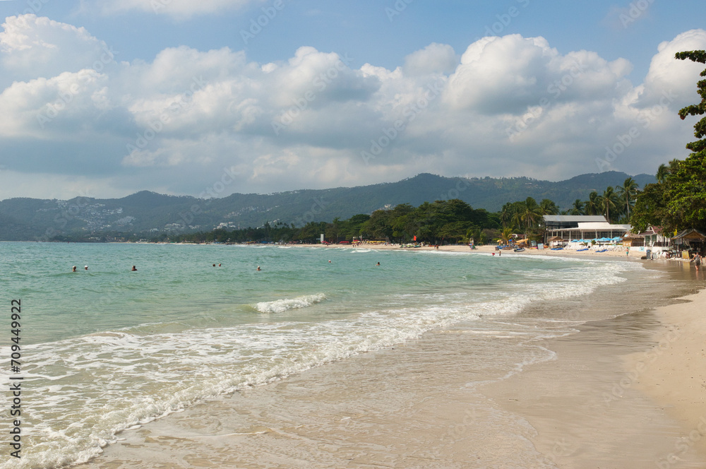 KOH SAMUI, THAILAND - JANUARY 14,2024: Beautiful beach. View of nice tropical beach with white sand ,blue sea and blue sky. Holiday and vacation concept. Tropical beach Chaweng Noi beach, Samui.