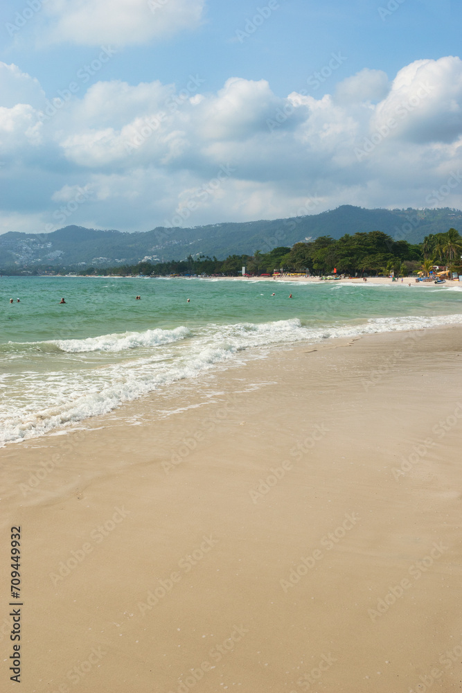 KOH SAMUI, THAILAND - JANUARY 14,2024: Beautiful beach. View of nice tropical beach with white sand ,blue sea and blue sky. Holiday and vacation concept. Tropical beach Chaweng Noi beach, Samui.