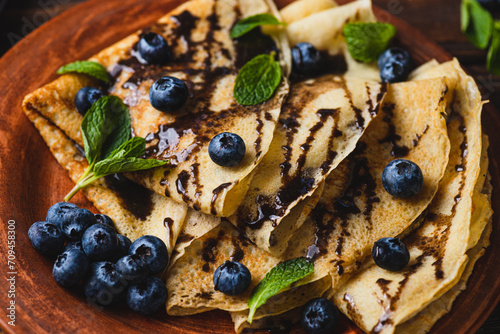 Pancakes with blueberries  chocolate sauce and mint