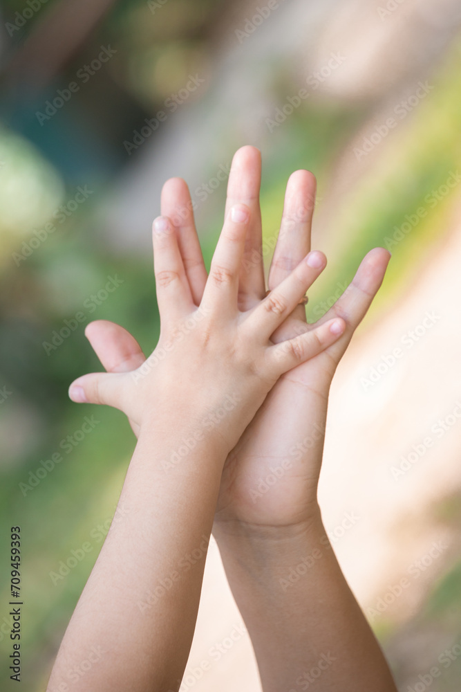 Little kid holding family member mother hand as a together family Little kid holding family member mother hand as a together family
