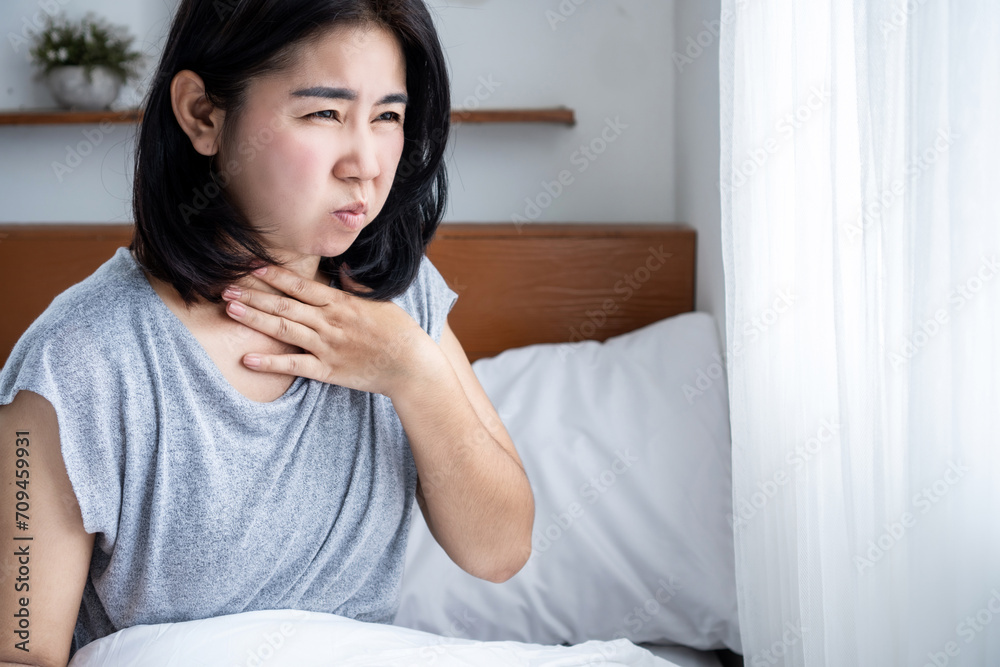 unwell Asian woman suffering from nausea in bed. food poisoning or pregnancy concept unwell Asian woman suffering from nausea in bed. food poisoning or pregnancy concept