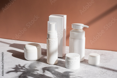 The white skincare container on beige background.