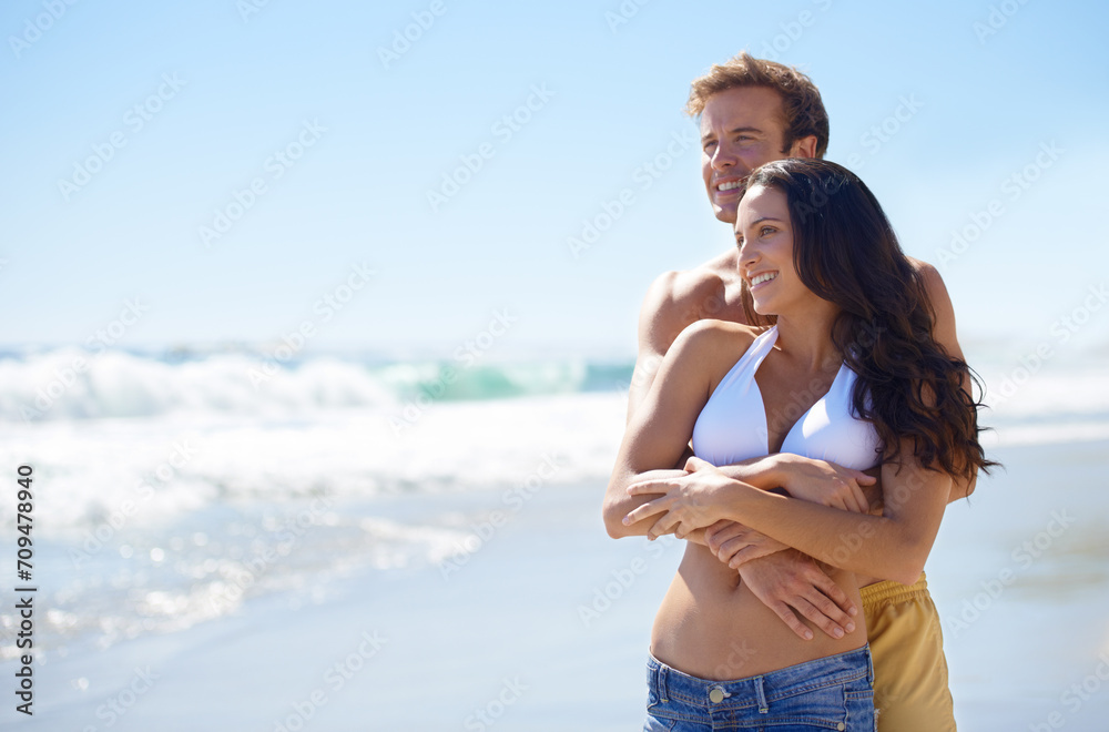 Embrace, love and happy couple on beach for holiday adventure together on tropical island with blue sky. Smile, man and woman on ocean vacation with waves, hug and mockup on romantic travel in Hawaii