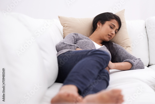 Sleeping, woman and sofa in the morning with rest, fatigue and nap in a home. Tired female person, couch and relax in a lounge with dreaming, house and living room with peace, sleepy and calm