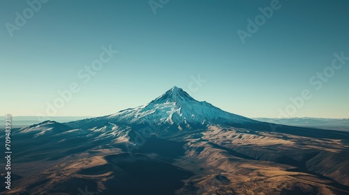 Aerial view of a lone, snow-capped mountain peak