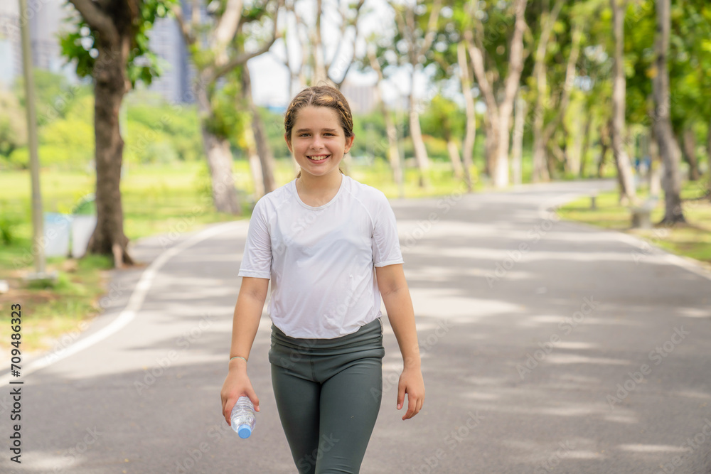 Cute little girl playing and jogging at the city park. Have fun and enjoy living outdoors during the summer holidays. Cute little girl playing and jogging at the city park. Have fun and enjoy living outdoors during the summer holidays.
