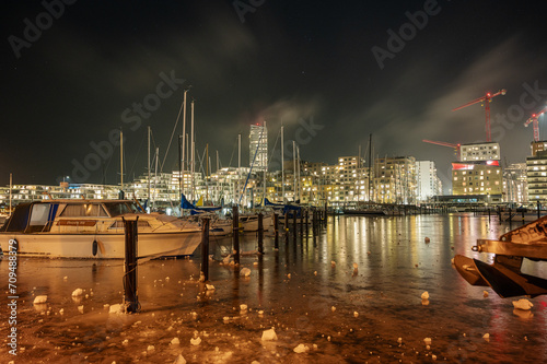 Long night expssure of Aarhus Island modern architecture and a frozen over marina in the foreground