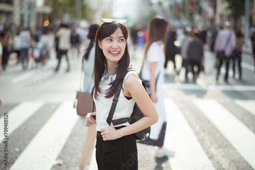 Urban synergy, Businessmen and women in Tokyo's bustling crosswalk, a dynamic fusion of work and lifestyle.