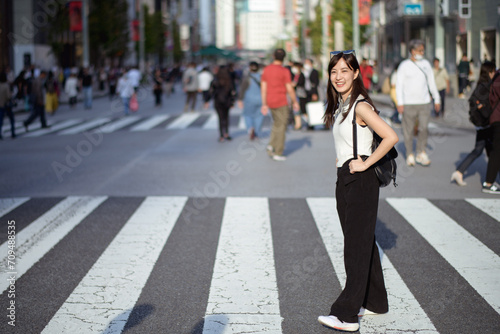 Tokyo swirl, Unrecognizable individuals navigating the urban crosswalk, a snapshot of daily activity.
