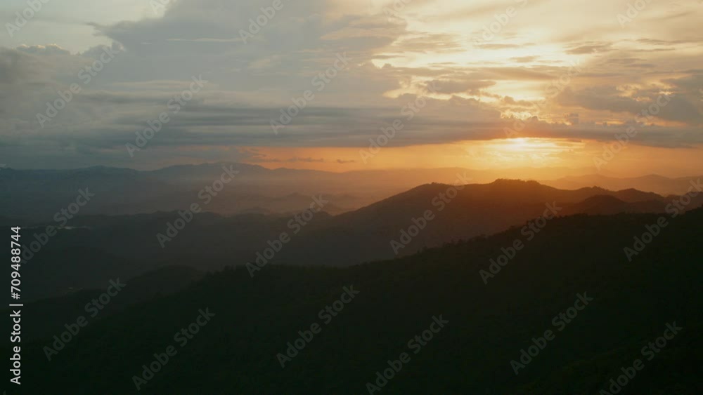 Timelapse of the evening clouds moving in the sunset sky above the mountains Timelapse of the evening clouds moving in the sunset sky above the mountains