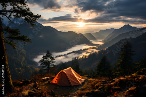 Camping on mountain in sunrise with fog and soft sunlight.