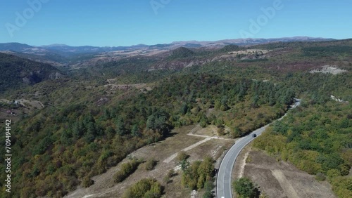 4K Drone Footage Captures Cars Journeying Through a Picturesque Countryside Forest Road near Birtvisi Canyon in Kvemo Kartli, Georgia; Showcasing Beautiful Forests and Stunning Landscape photo