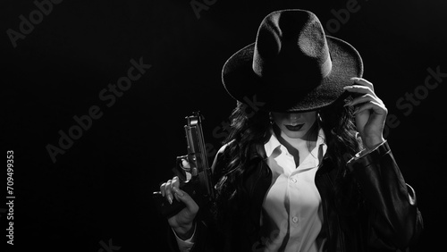 Silhouette of a female detective in a coat and hat with a gun in her hands. A book drama noir portrait in the style of detectives of the 1950s.