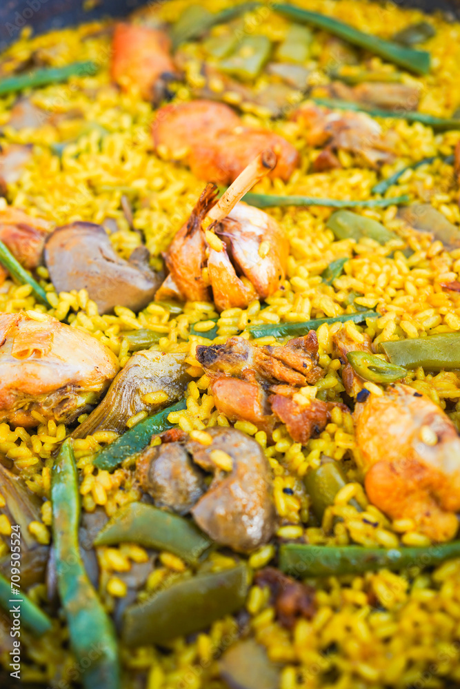 Detailed view of traditional Valencian paella with chicken Detailed view of traditional Valencian paella with chicken