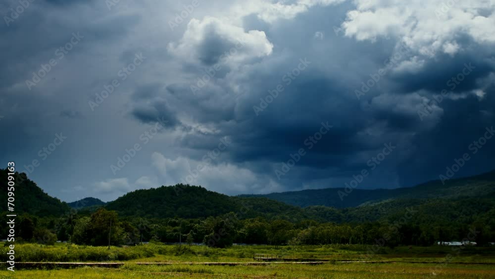Timelapse of the rainy clouds moving in the sky above the green fields Timelapse of the rainy clouds moving in the sky above the green fields