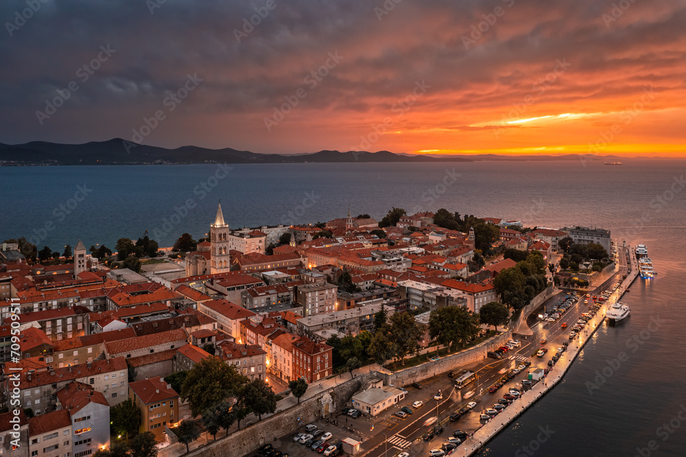 Zadar, Croatia - Aerial panoramic view of the Old Town of Zadar with Cathedral of St. Anastasia and a dramatic golden summer sunset at background