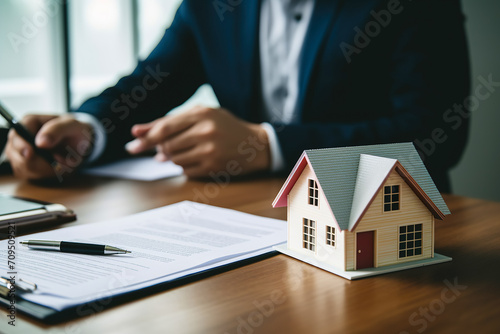 Real estate agent explained the terms and conditions of home Concept for selling house and home insurance. Concluding contract for the purchase and sale of house, rental housing, property insurance.