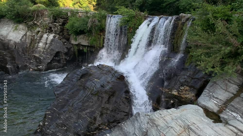 Waterfalls Flowing Down on Boulders In The River. - wide shot Waterfalls Flowing Down on Boulders In The River. - wide shot