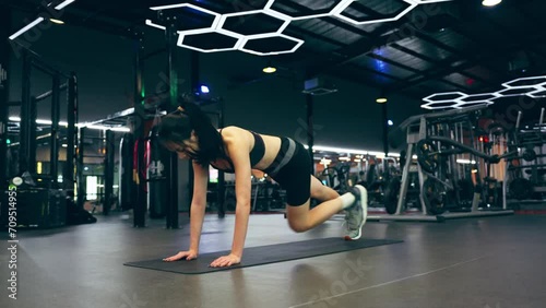 Young asian woman training exercise plank position at fitness center. Healthy and bodybuilder concept photo