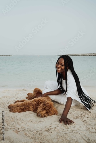 Woman playing with her dog at the beach